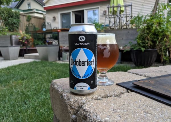 Old Nation Oktoberfest can and glass in a backyard. 